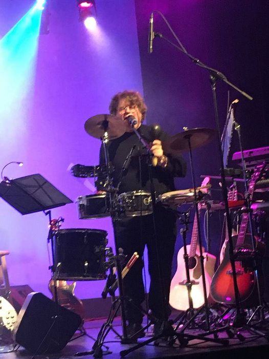 john lennon tribute band member on stage