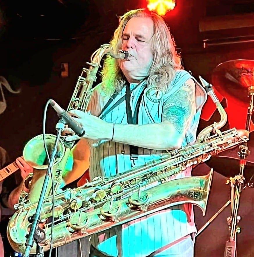 john lennon tribute band member on saxophone